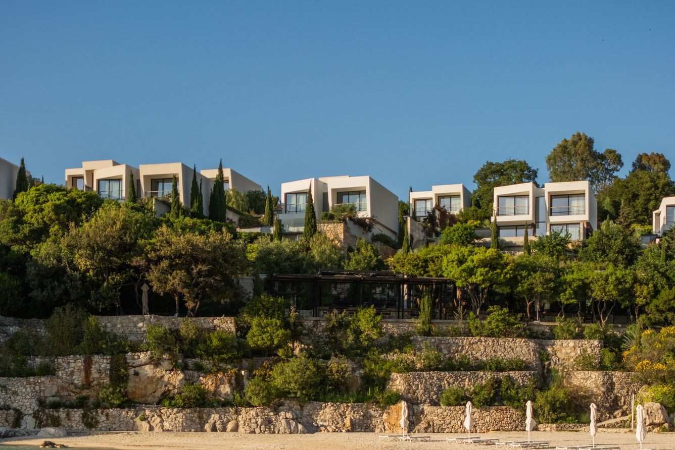 White villas at Kep Merli above a sandy cove on the Ionian coast near Ksamil
