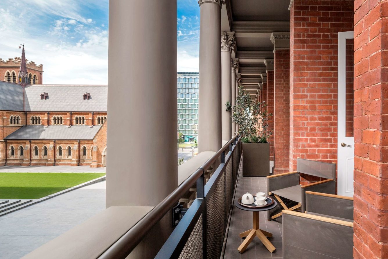 A balcony terrace at COMO The Treasury in Perth, overlooking St George's Cathedral and the Supreme Court Gardens