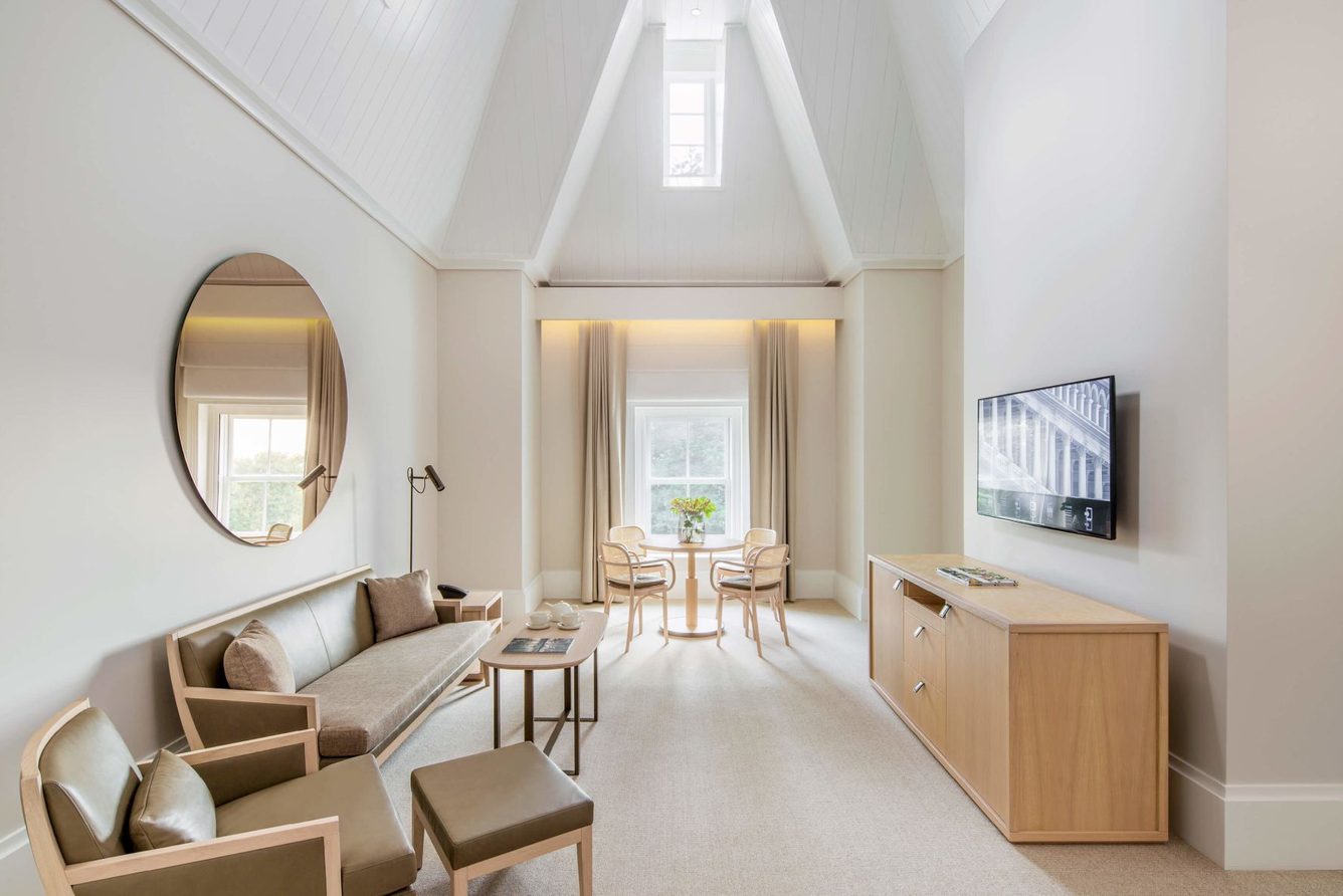 The living area of a suite at COMO The Treasury, under a vaulted ceiling
