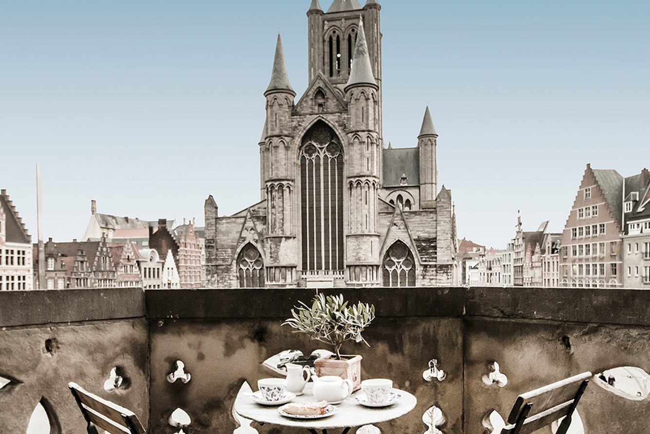 The Carriage Terrace at 1898 The Post in Ghent, set for coffee with a view to St Bavo's Cathedral