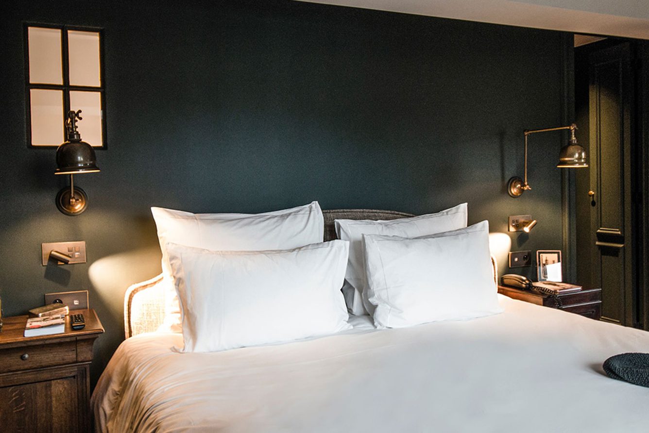 Suite 18 at 1898 The Post, with dark green walls and a king bed