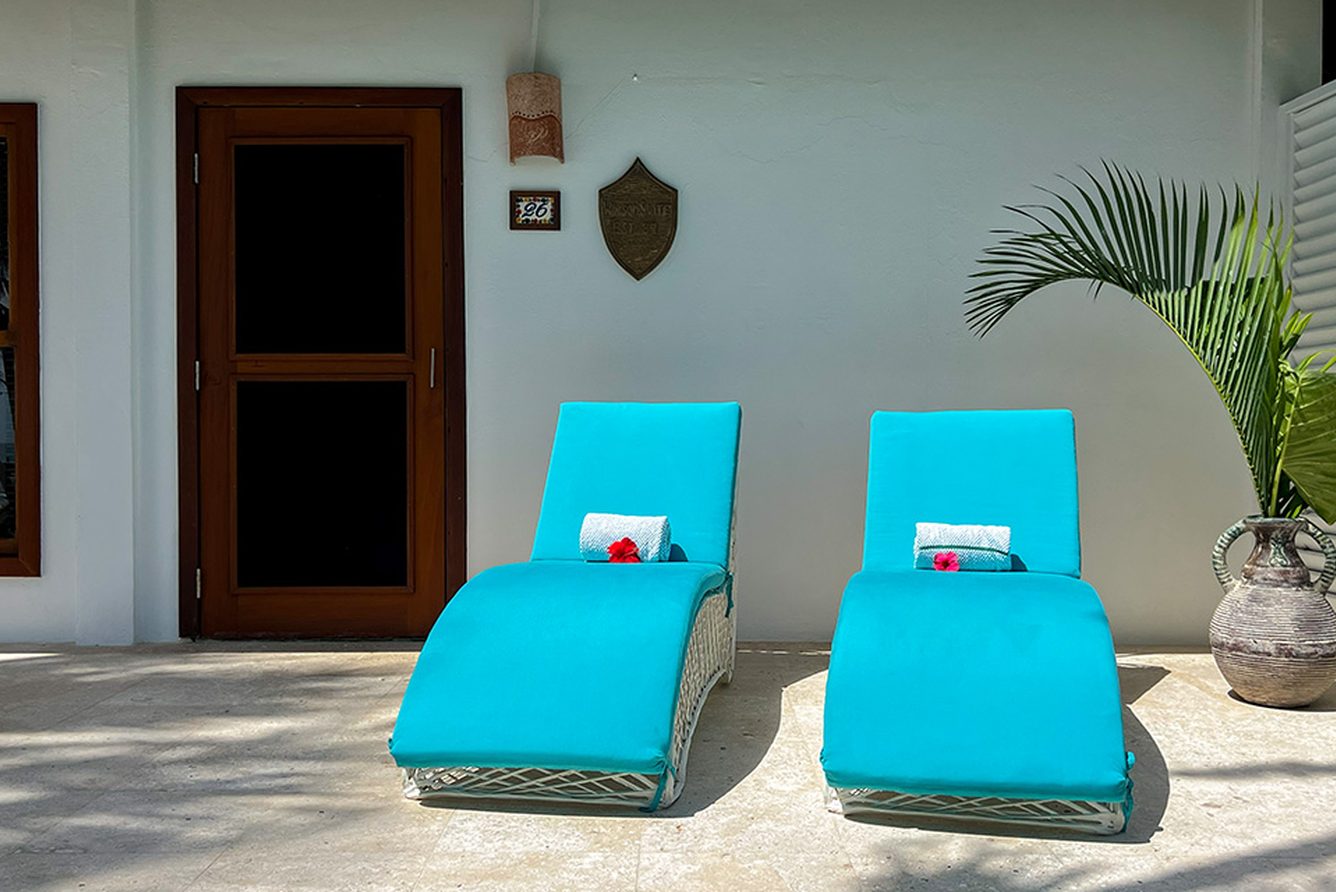 Private terrace with turquoise loungers outside a villa at Victoria House