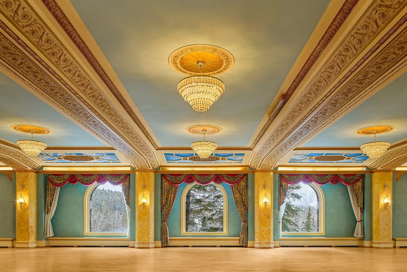 An ornate ballroom with a painted ceiling at Fairmont Banff Springs