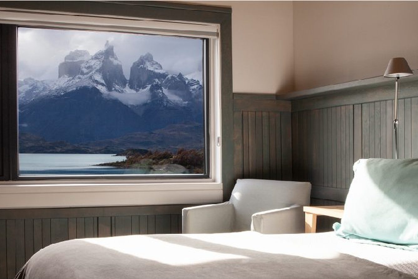 A Cordillera Paine room at Explora Torres del Paine, its window framing the Paine massif