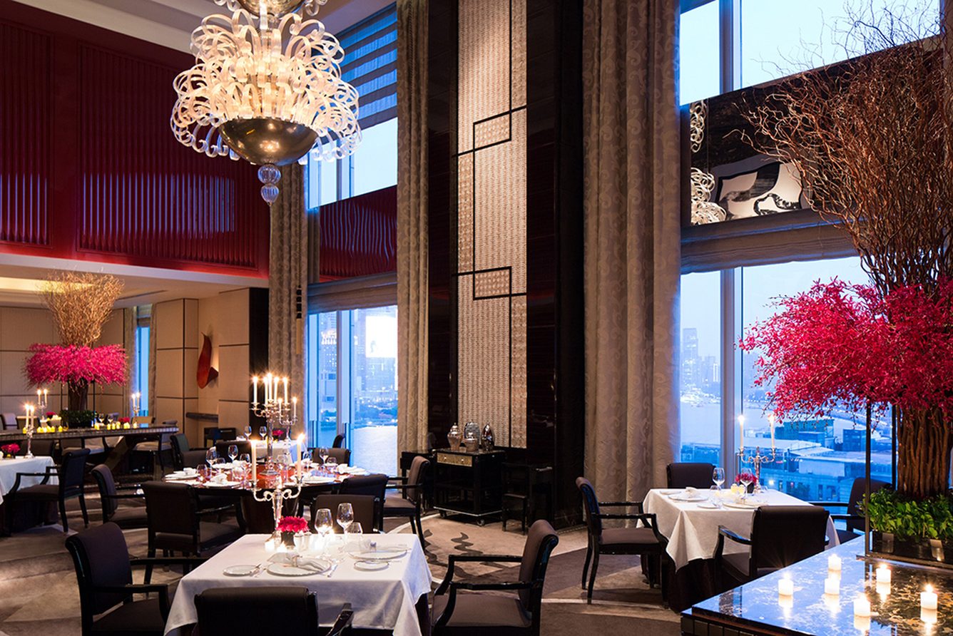 Sir Elly's restaurant at The Peninsula Shanghai, with double-height windows over the Huangpu River
