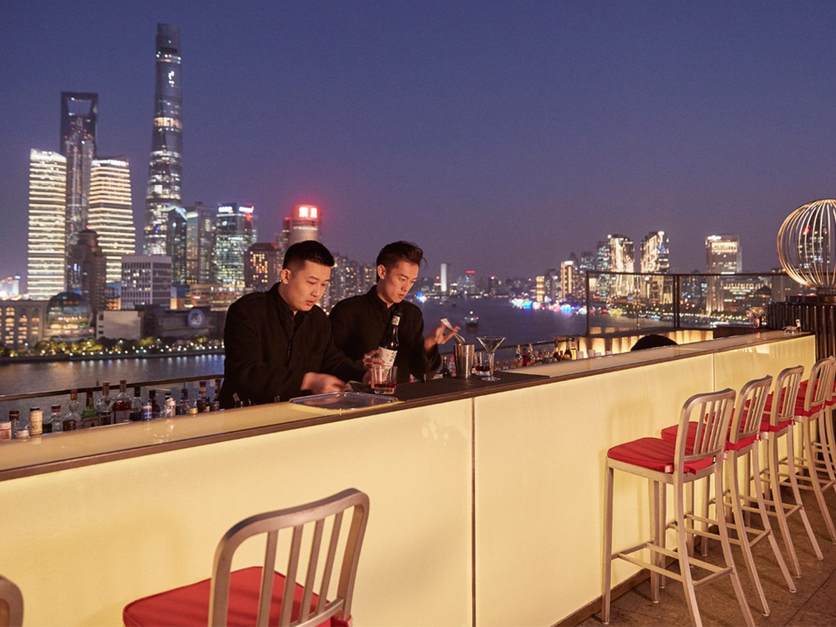 Sir Elly's rooftop terrace at The Peninsula Shanghai, facing the Lujiazui towers across the Huangpu River