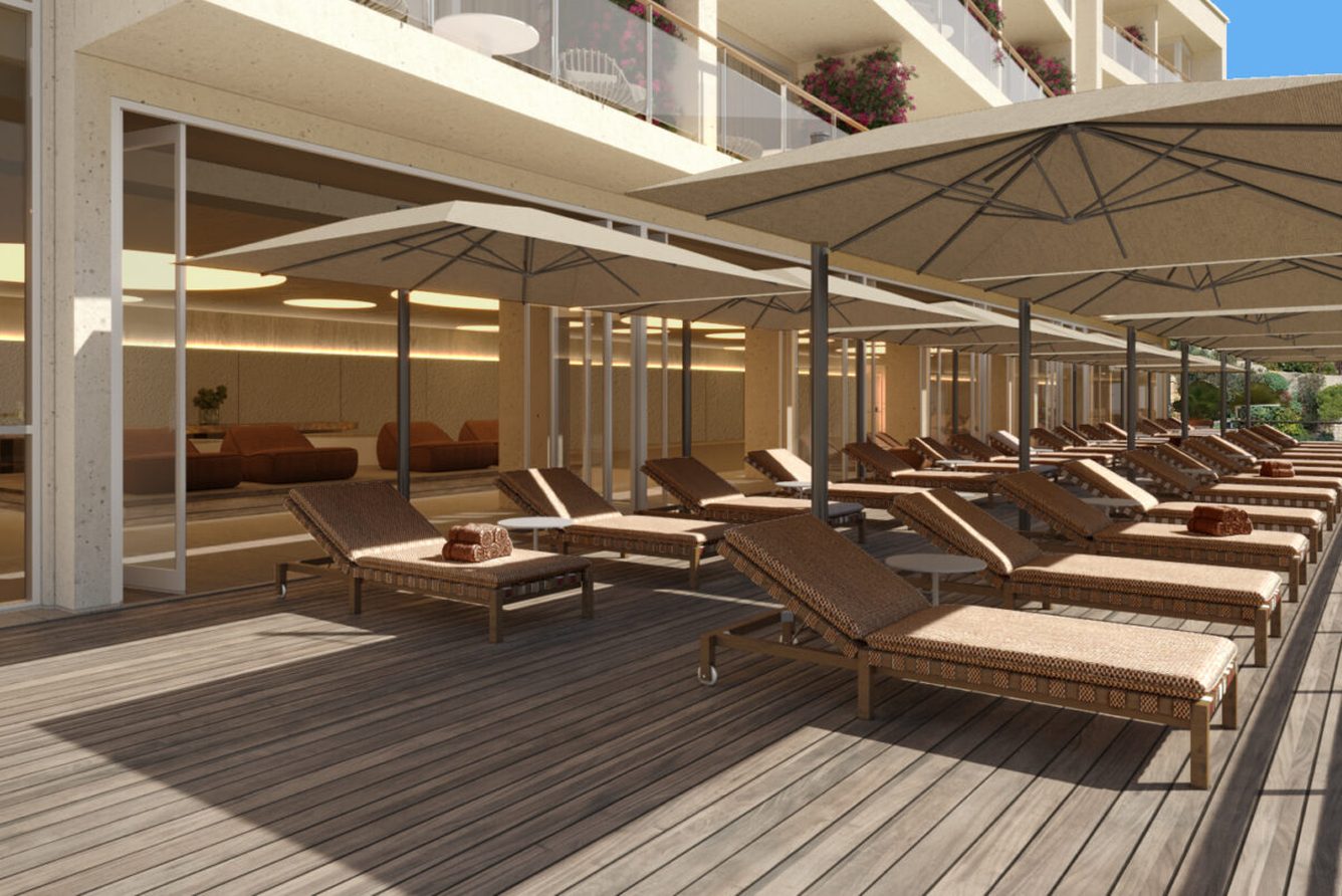 The Villa Spa sundeck at Villa Dubrovnik, with rows of loungers and parasols on a wooden terrace
