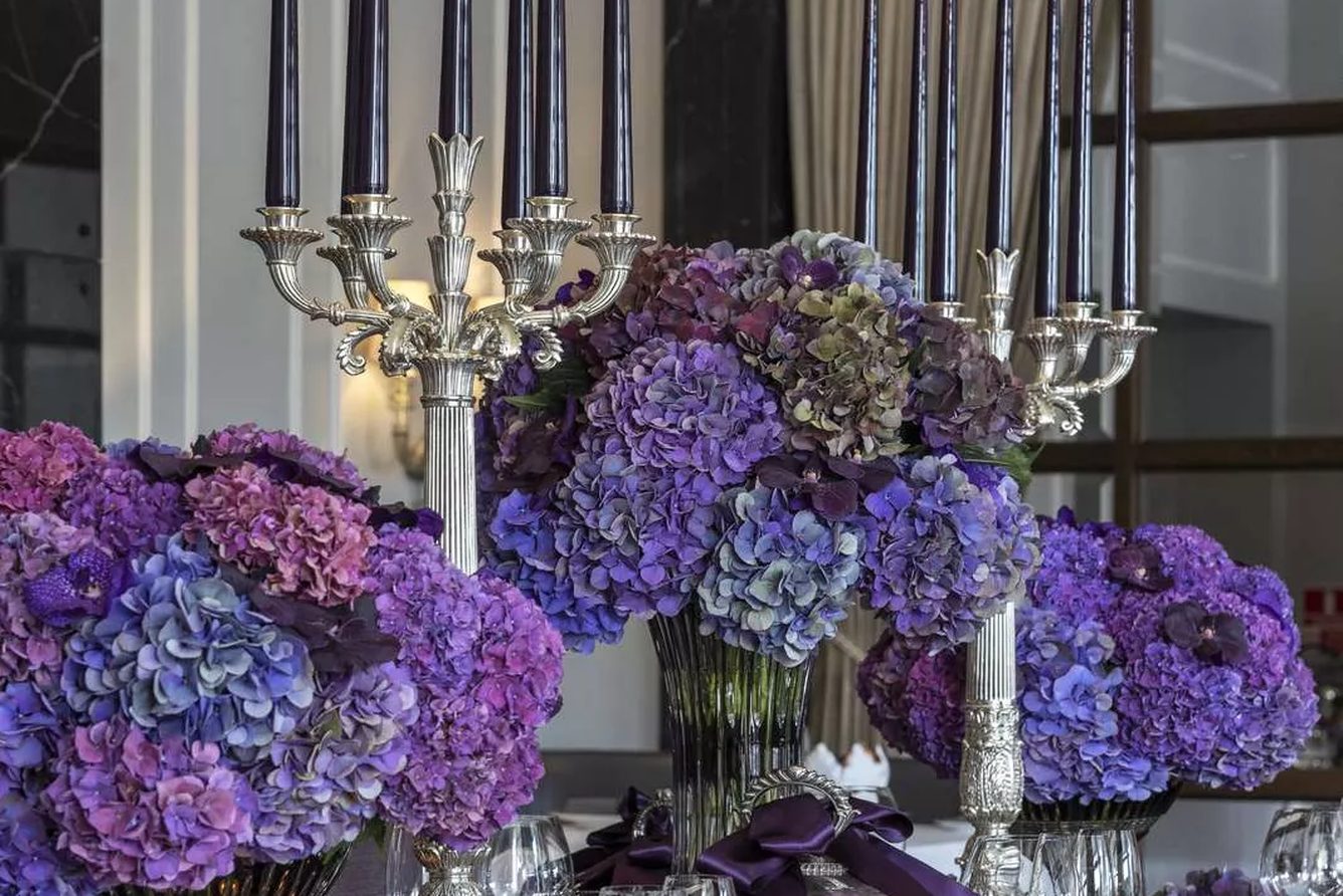 A set table at Restaurant Marchal, with candelabra and hydrangea arrangements