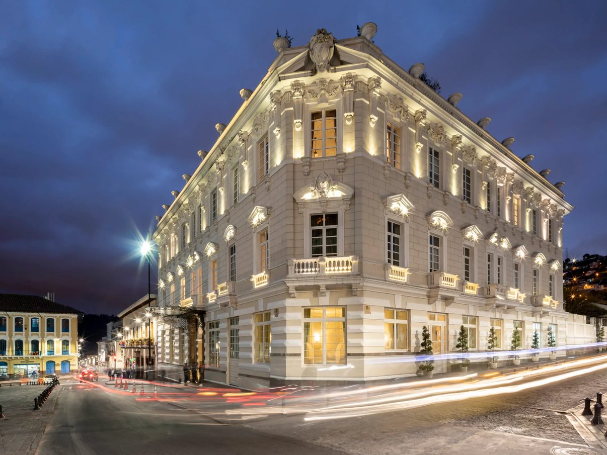 Casa Gangotena's illuminated mansion facade on Plaza San Francisco at night, Quito