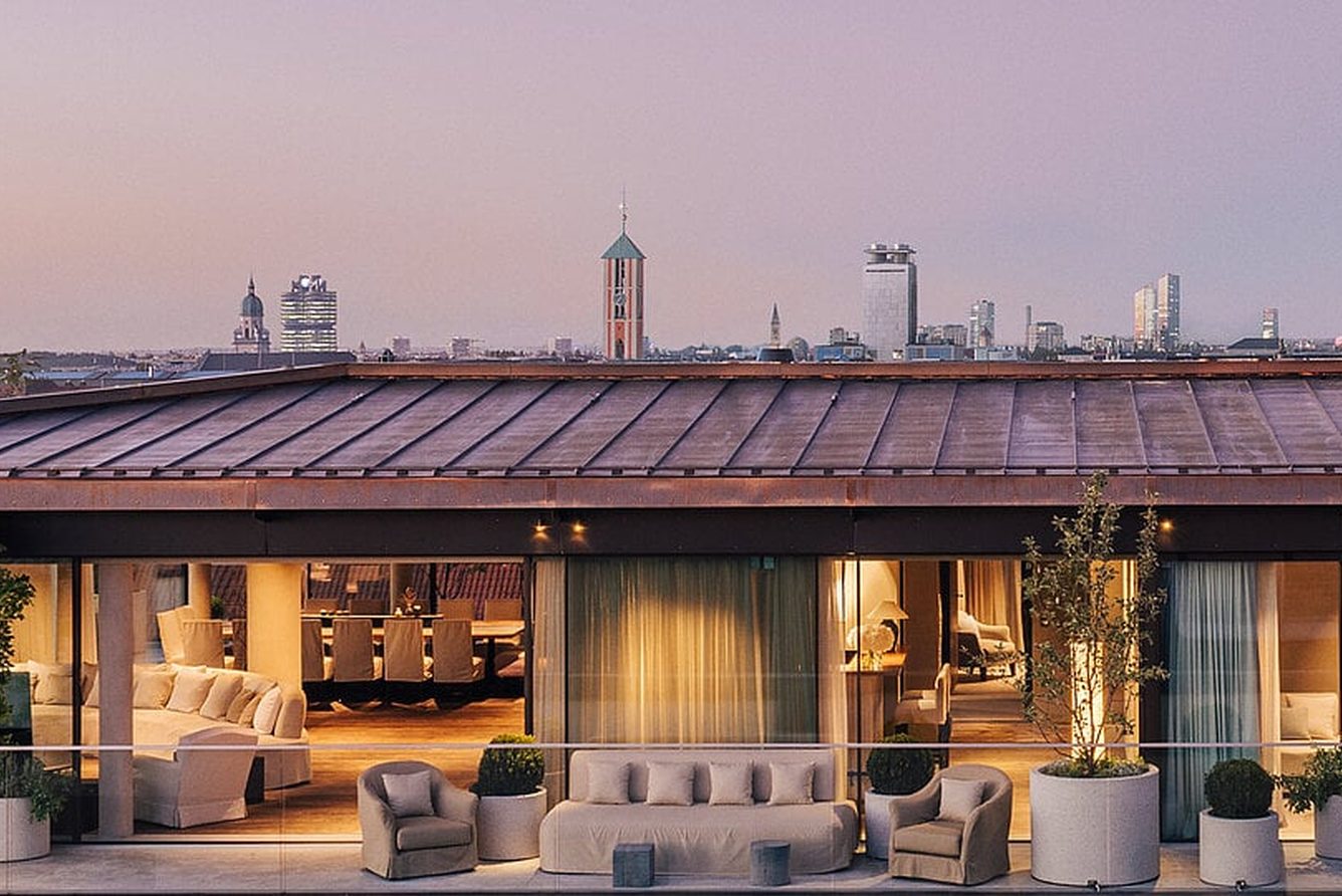 The rooftop terrace at the Hotel Bayerischer Hof at dusk, looking over Munich
