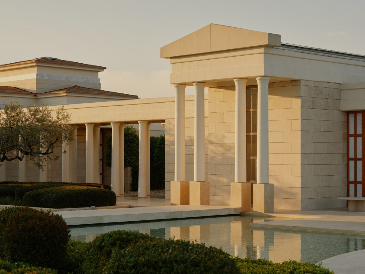 The hilltop pavilions and grounds at Amanzoe, looking over olive groves towards the Aegean Sea