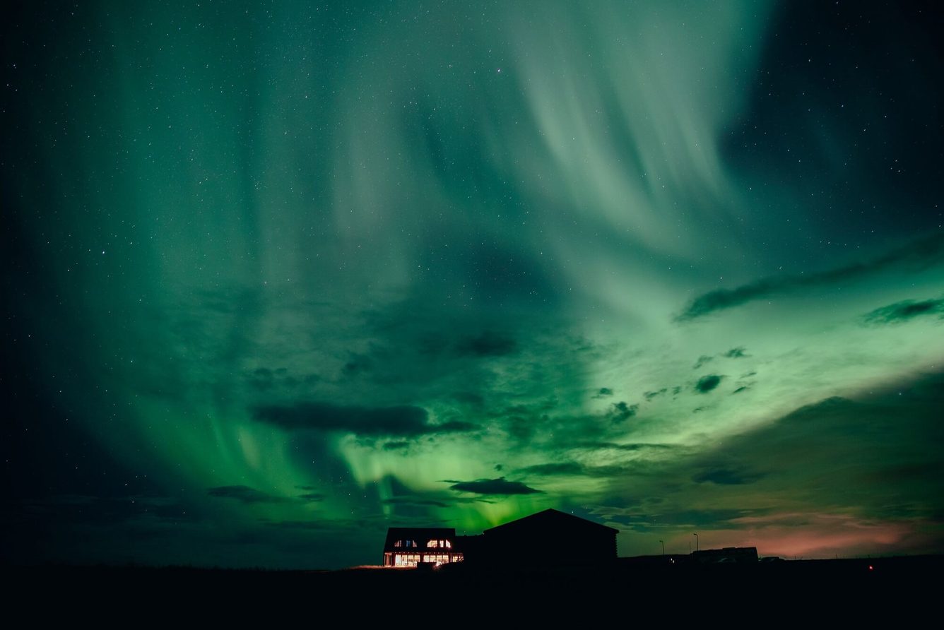 Hotel Rangá silhouetted under the northern lights near Hella in South Iceland
