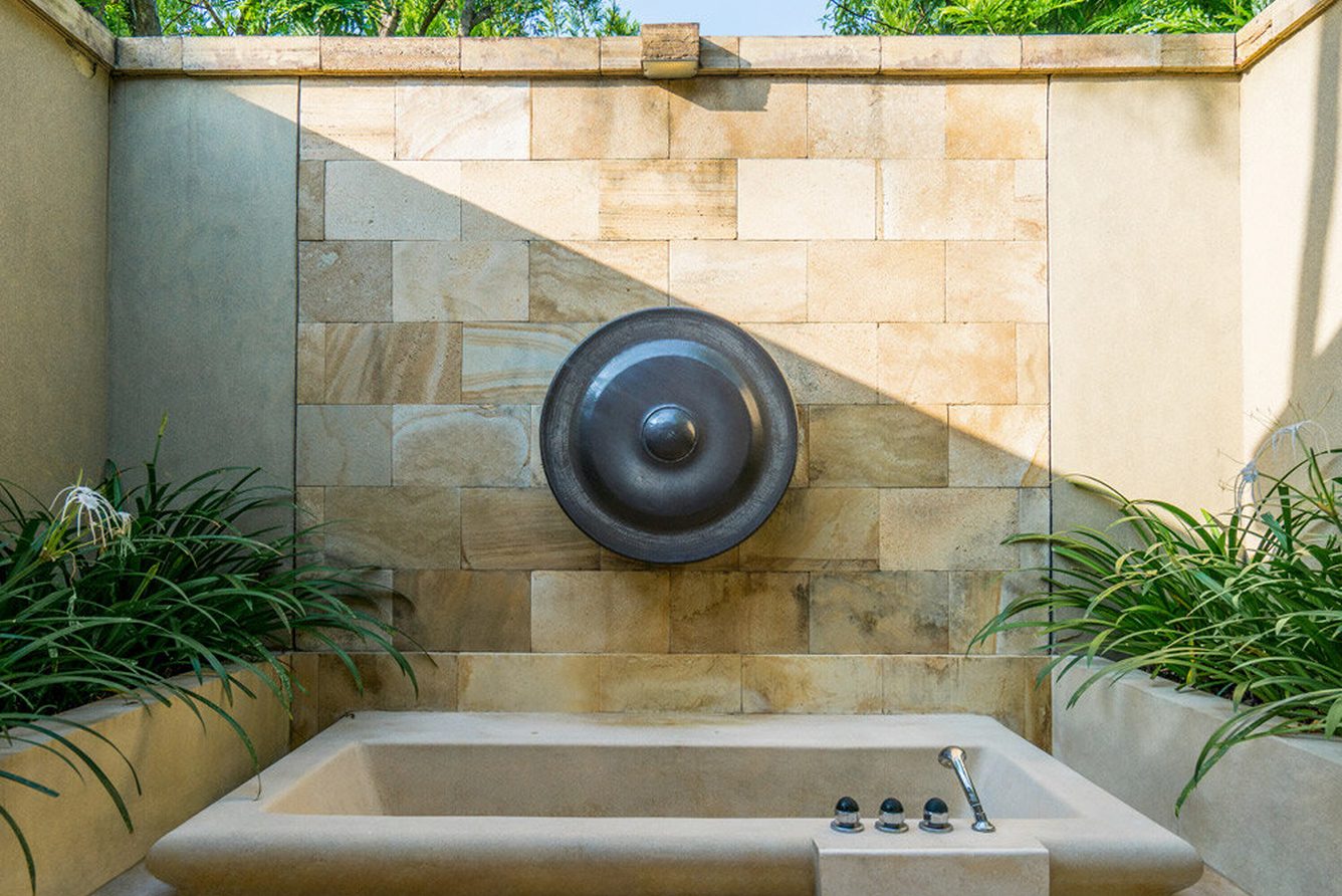 An outdoor sunken bath in a walled garden suite at Amanjiwo