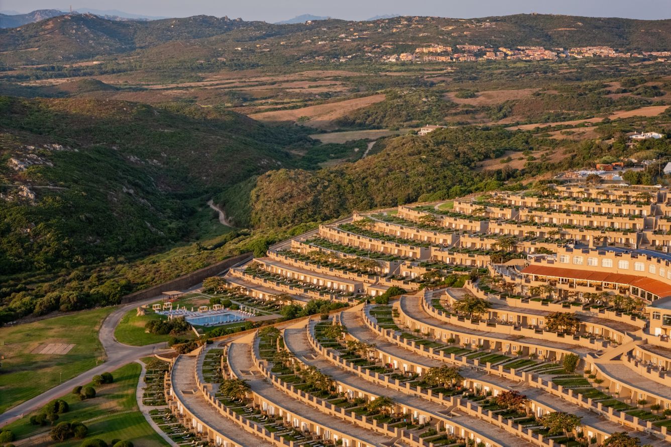 Aerial view of the terraced resort buildings in golden light