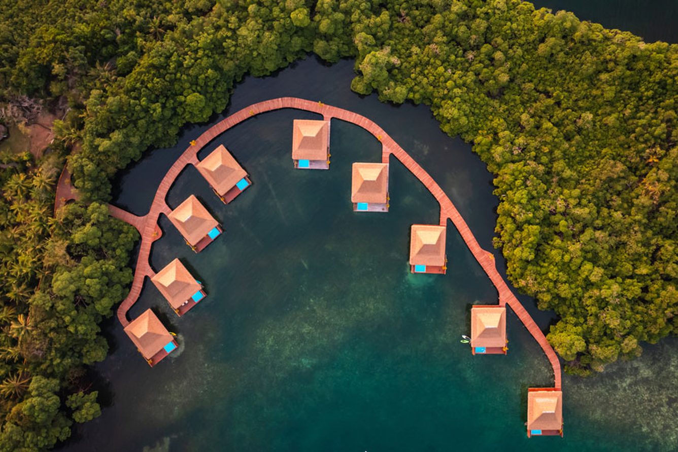 Top-down aerial of Nayara Bocas del Toro's overwater villas and their curving boardwalk
