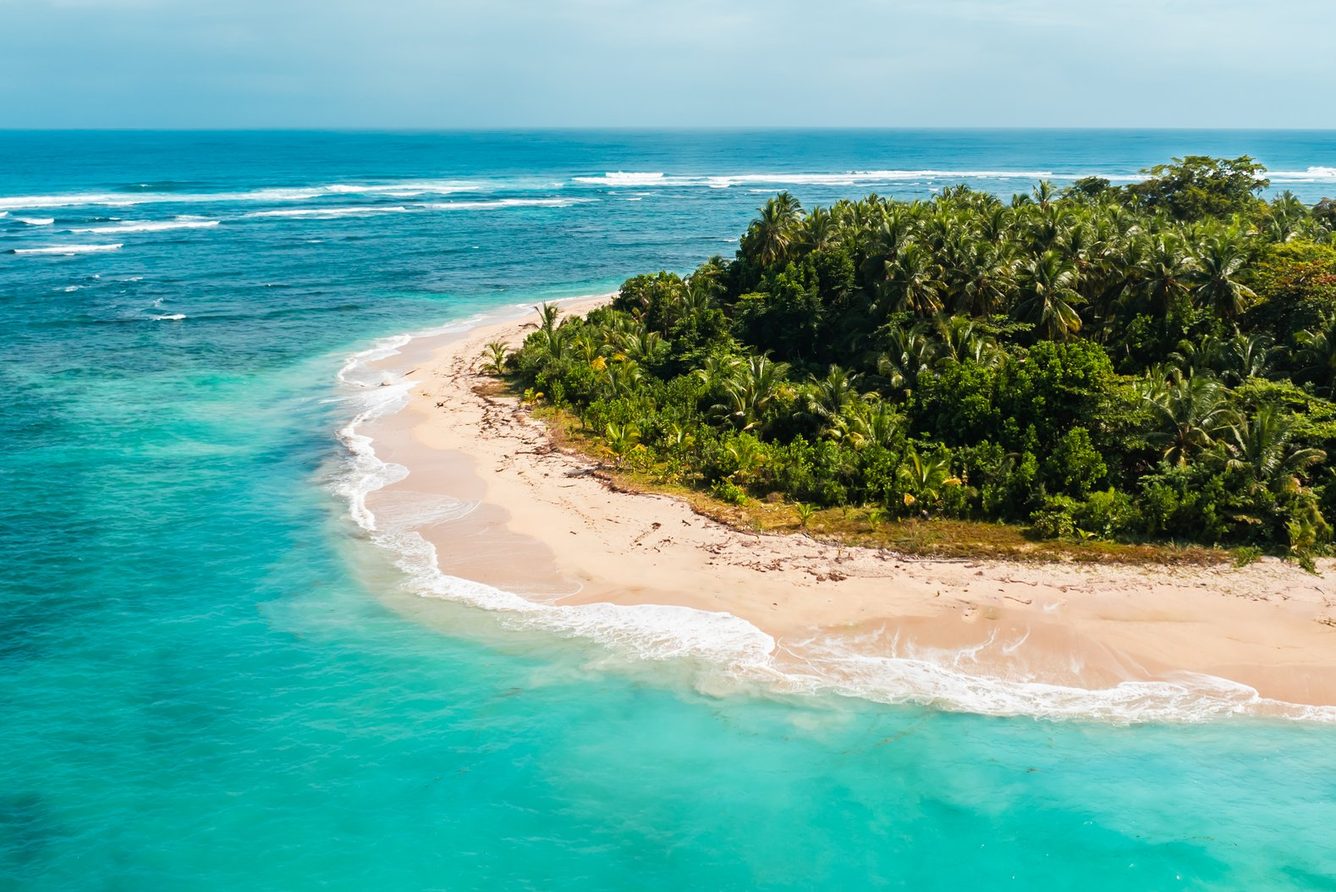 A small cay in the Bocas del Toro archipelago ringed by turquoise water, near Nayara