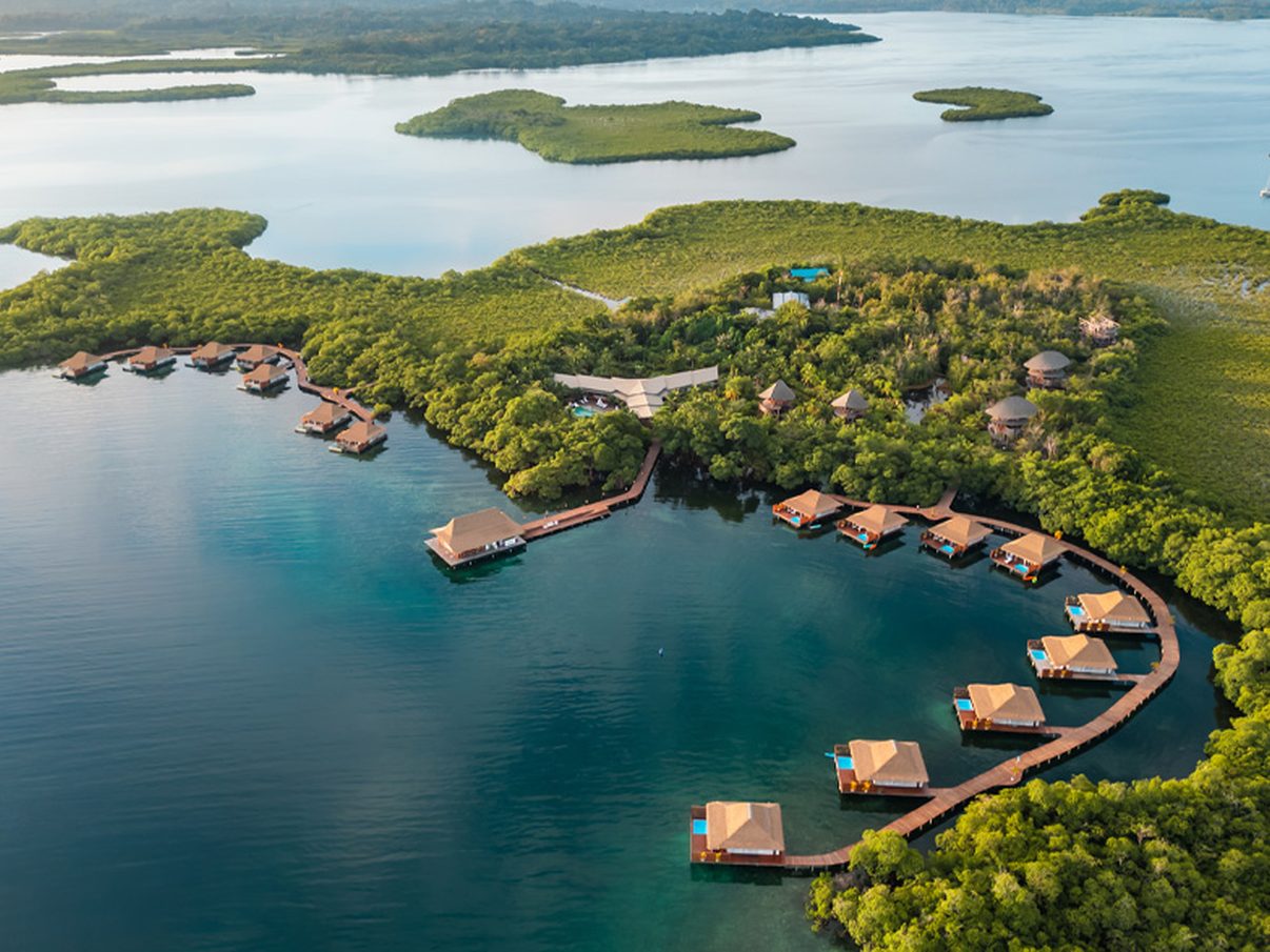 Aerial view of Nayara Bocas del Toro, its overwater villas curving around the shore of Isla Frangipani