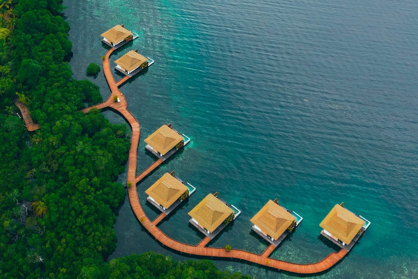 Aerial view of overwater villas at Nayara Bocas del Toro above turquoise Caribbean water