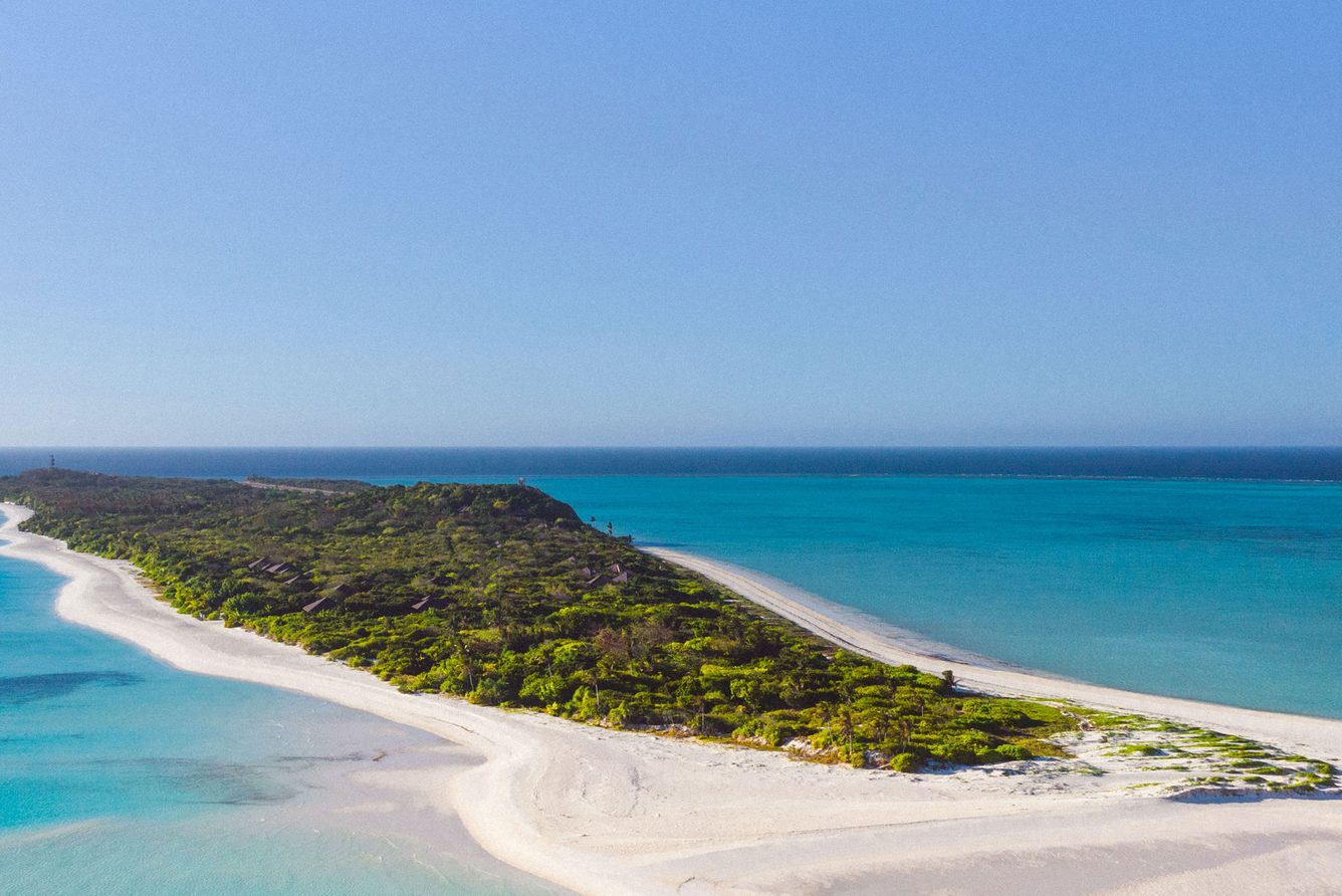 Aerial view of Pamalican Island's white-sand shore and turquoise reef at Amanpulo in Palawan, the Philippines