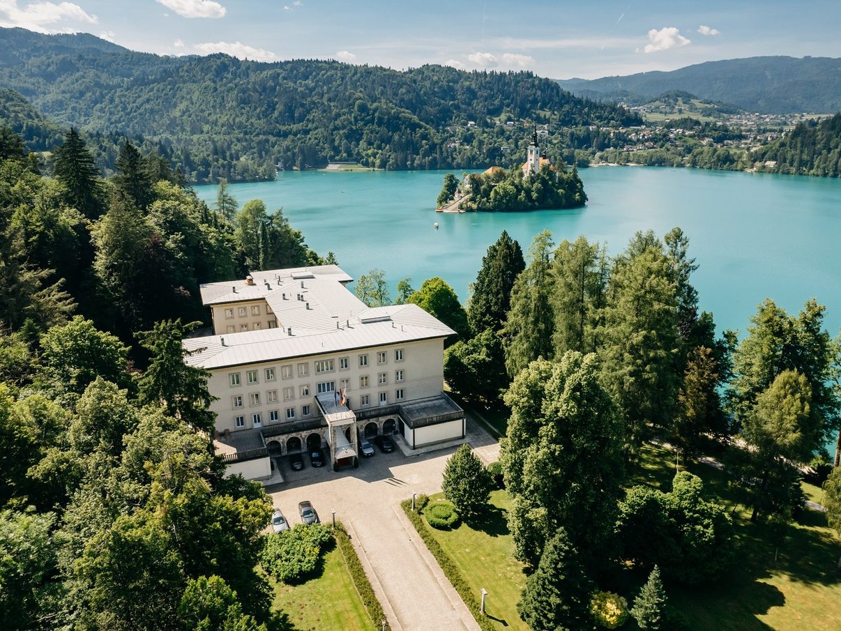 Vila Bled from the air, in its park on the shore of Lake Bled with the island church behind