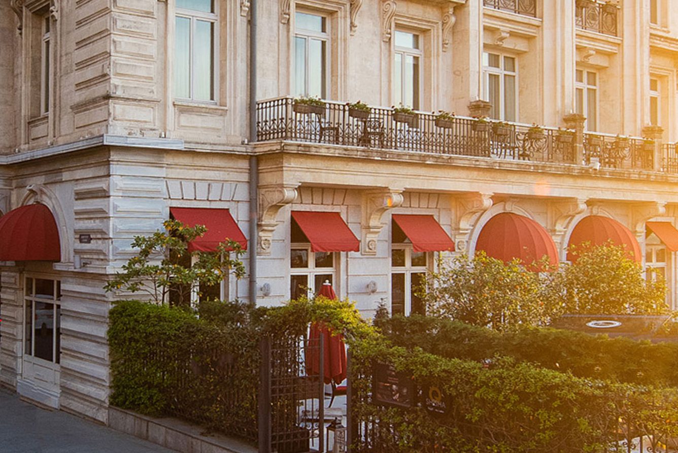 Pera Palace Hotel's stone facade with red awnings on Meşrutiyet Caddesi in Beyoğlu, Istanbul
