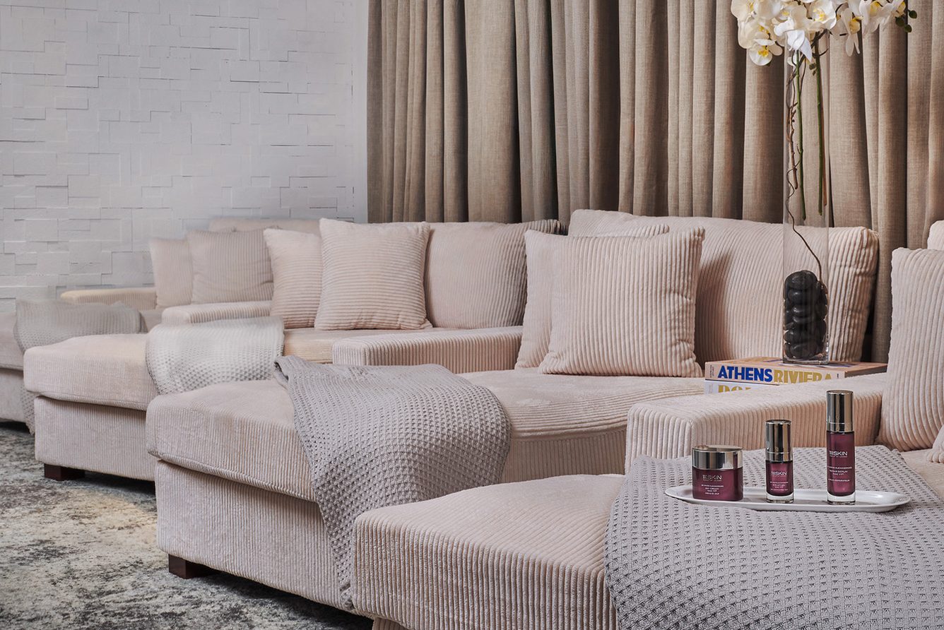A suite living room at The Plaza with a cream sofa and tall windows