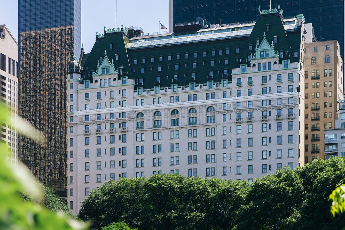 The Plaza hotel rising above the trees of Central Park at Fifth Avenue in New York City