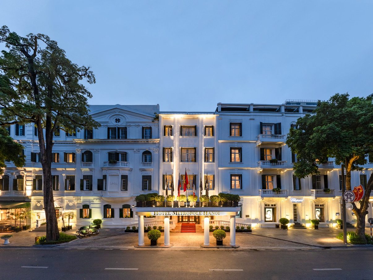 The floodlit French colonial facade of Sofitel Legend Metropole Hanoi at night